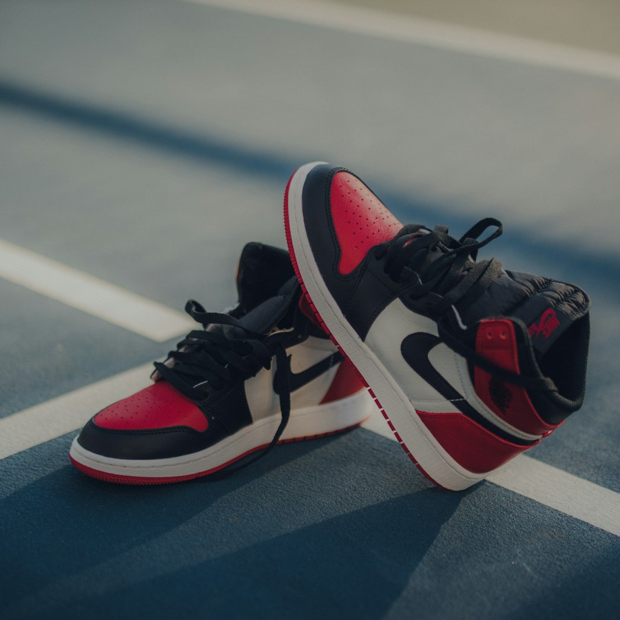Red, black and white leather sneakers on a running track